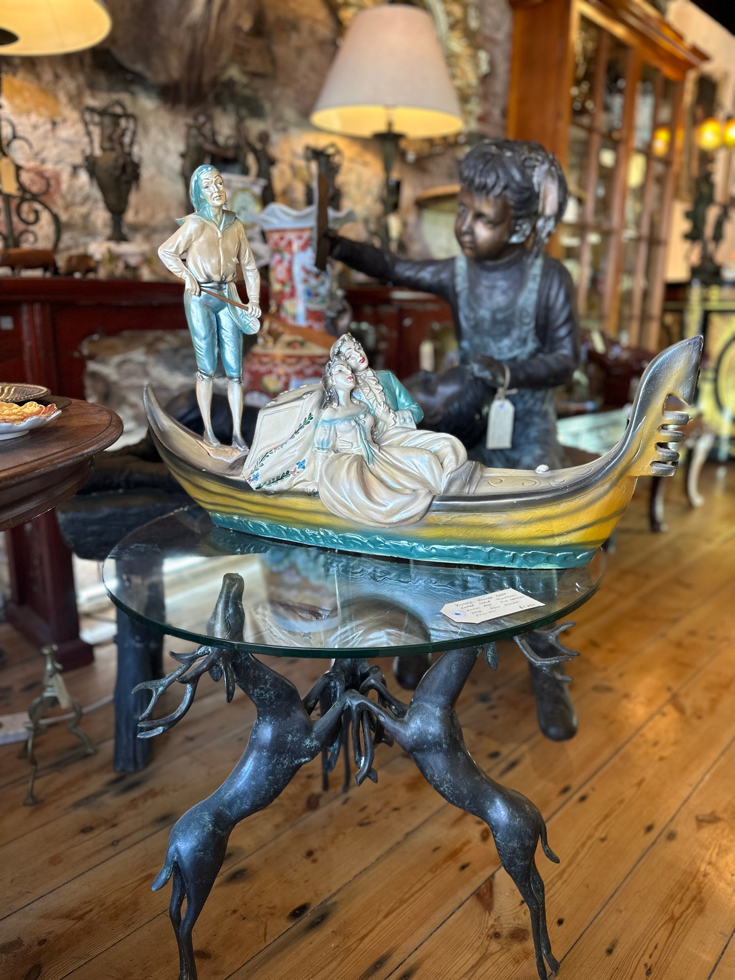 Vintage Venetian Gondola with Romantic Couple and Standing Gondolier with Wooden Oar
