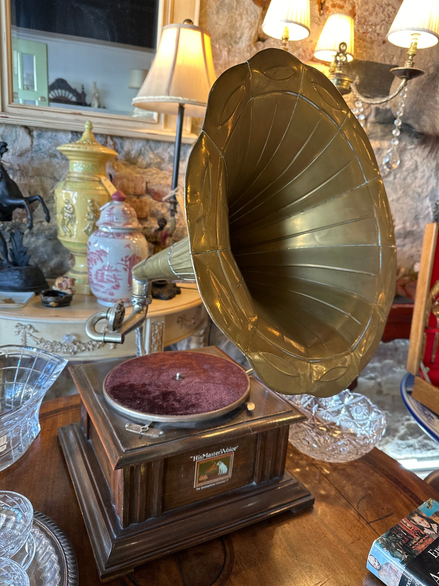 Vintage Gramophone HMVS, with a wooden base, a side hand crank, and a large brass horn.
