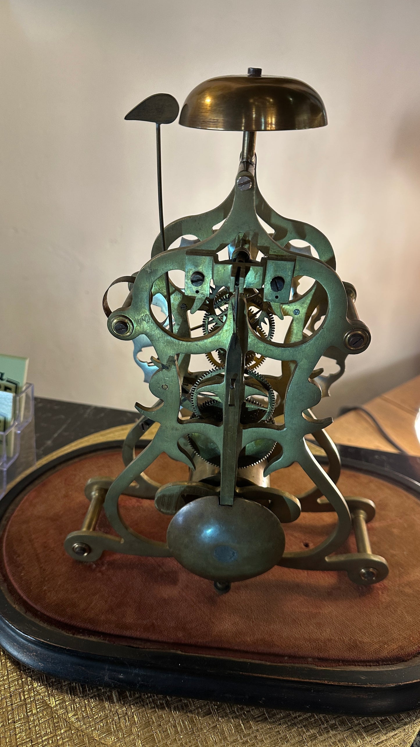 Antique Skeleton Clock incased in blown glass dome
