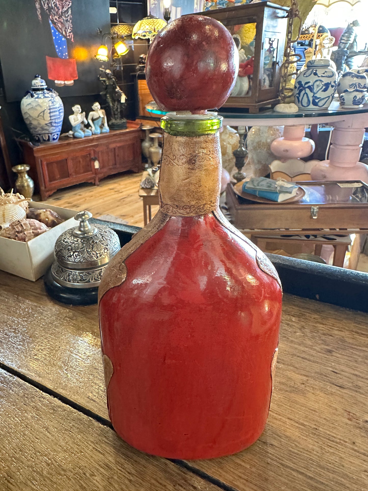 Vintage leather wrapped green bottle with painted hunting scene