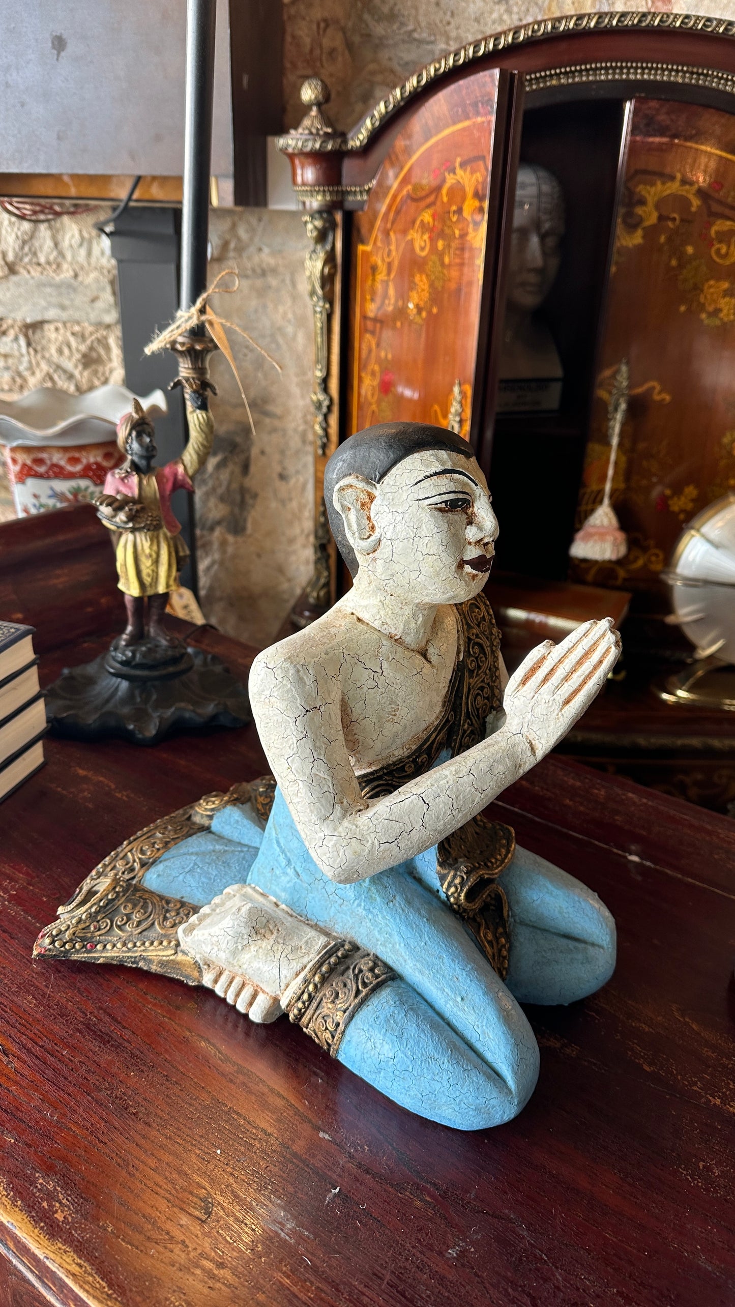 Vintage carved wooden sculpture of a praying monk