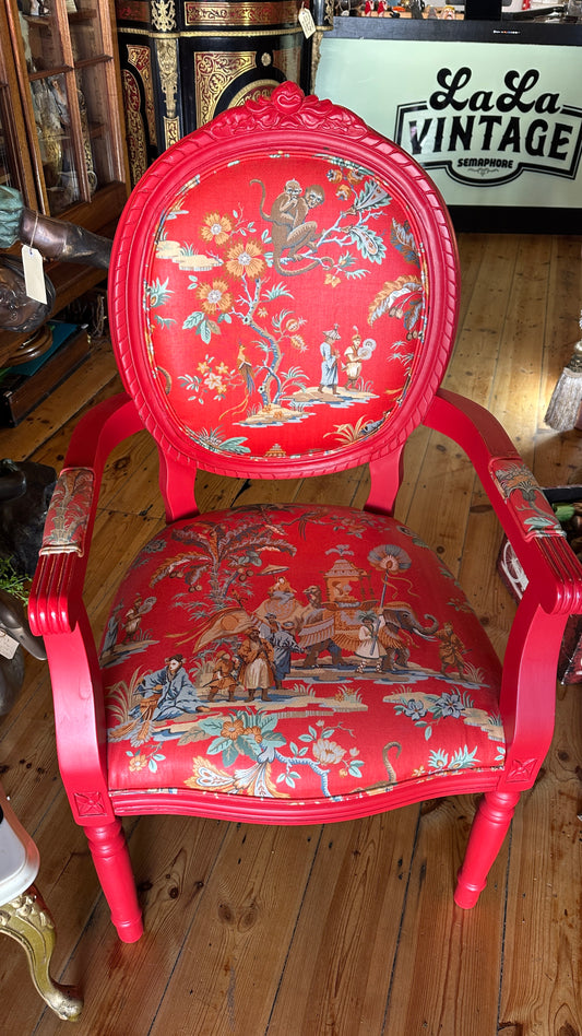 Striking Louis XVI-style armchair exquisitely upholstered in a red Chinoiserie garden scene motif