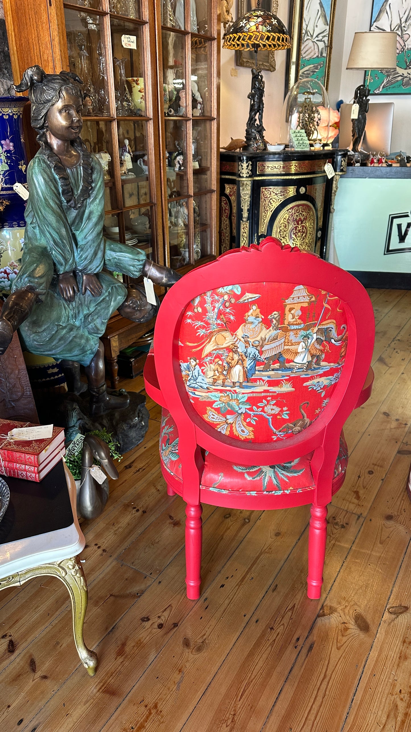 Striking Louis XVI-style armchair exquisitely upholstered in a red Chinoiserie garden scene motif