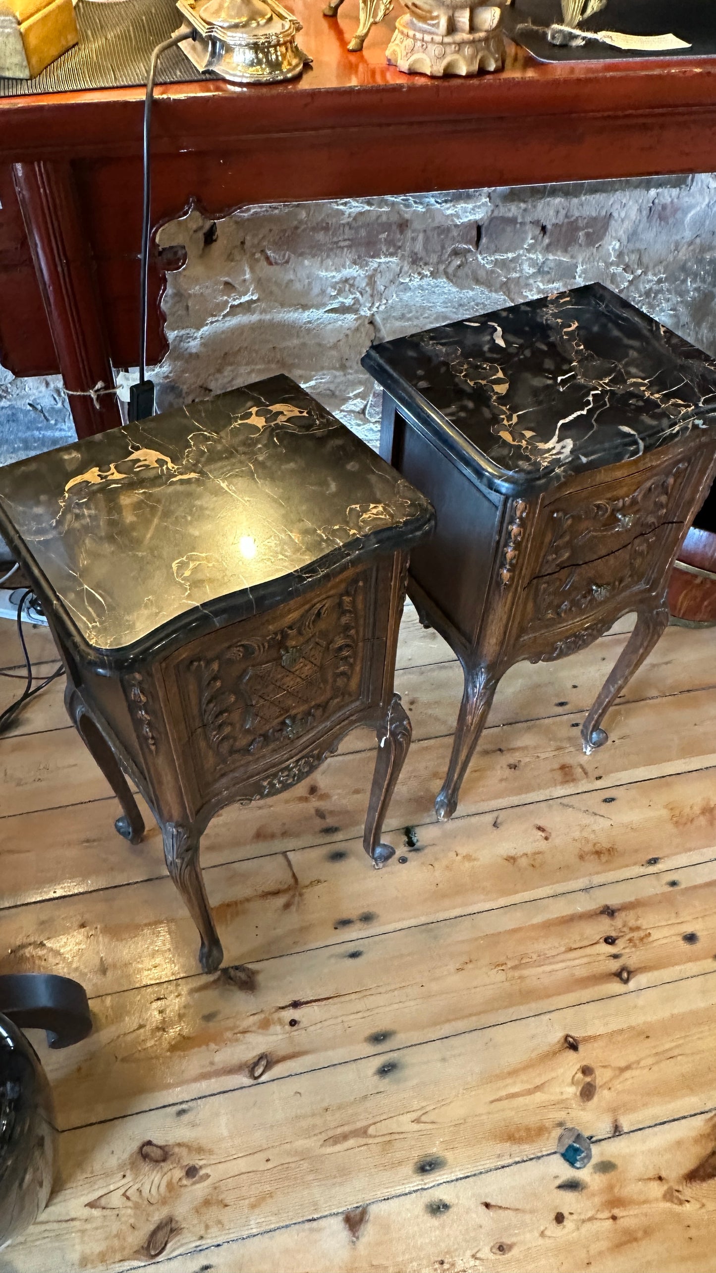 Antique 19th-century French Louis XV style walnut side table with a black marble top and intricate Rococo carving, with two drawers