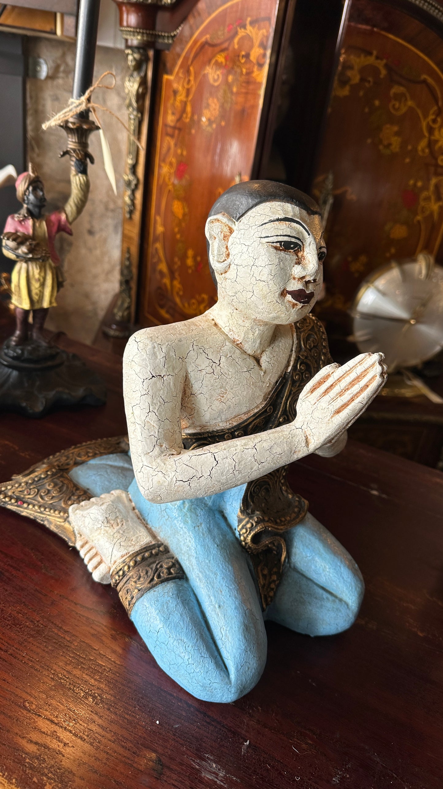Vintage carved wooden sculpture of a praying monk