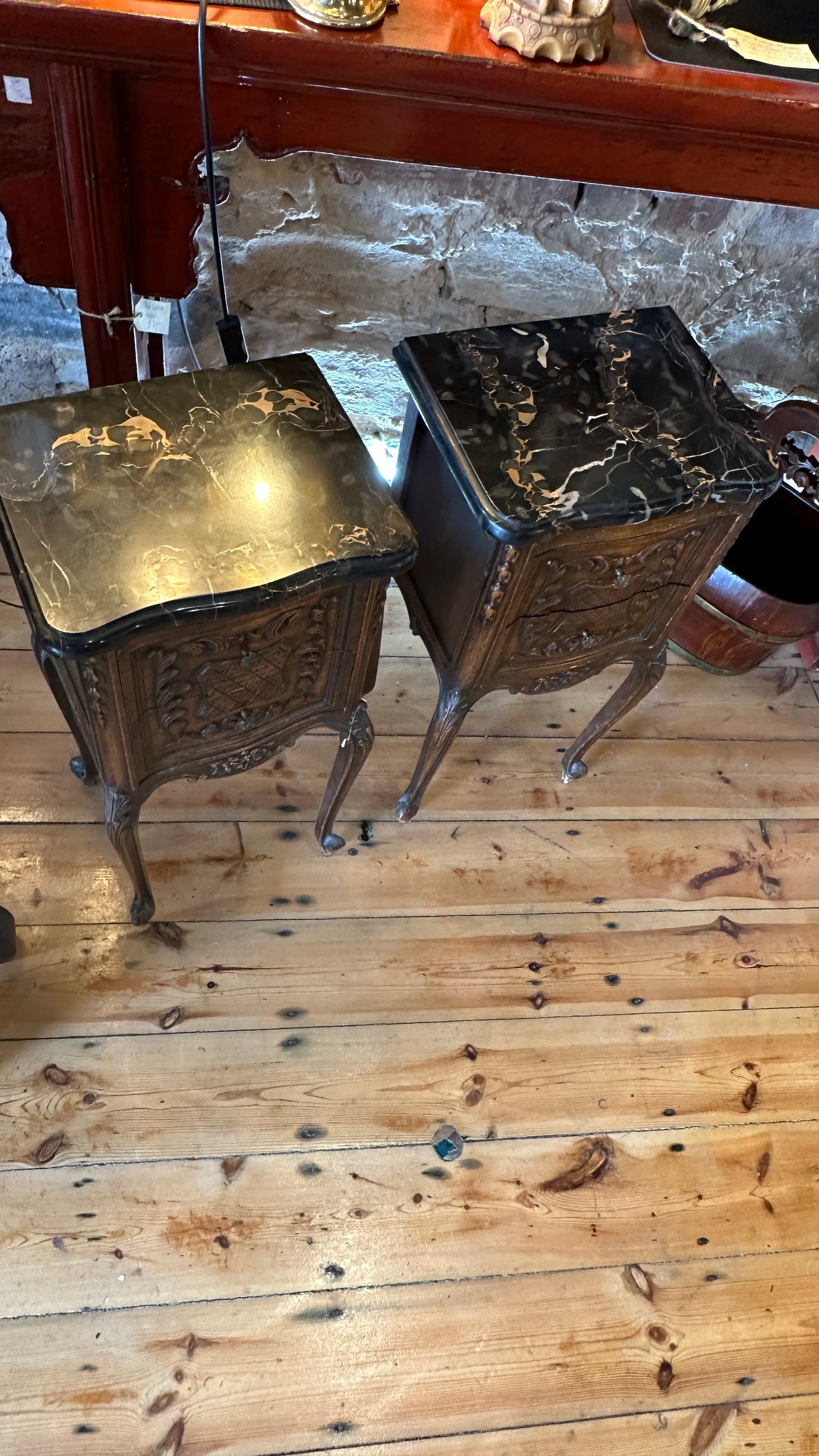 Antique 19th-century French Louis XV style walnut side table with a black marble top and intricate Rococo carving, with two drawers