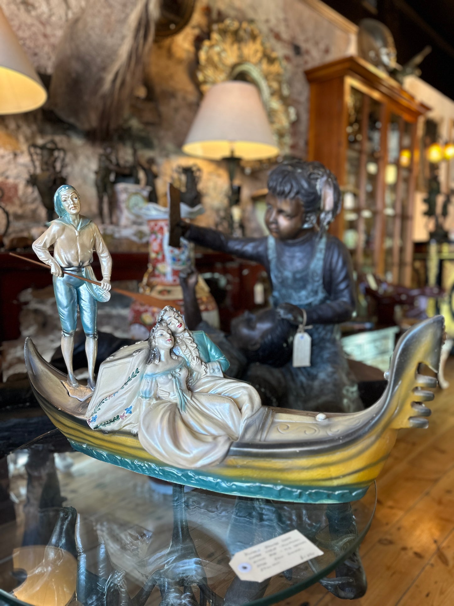 Vintage Venetian Gondola with Romantic Couple and Standing Gondolier with Wooden Oar