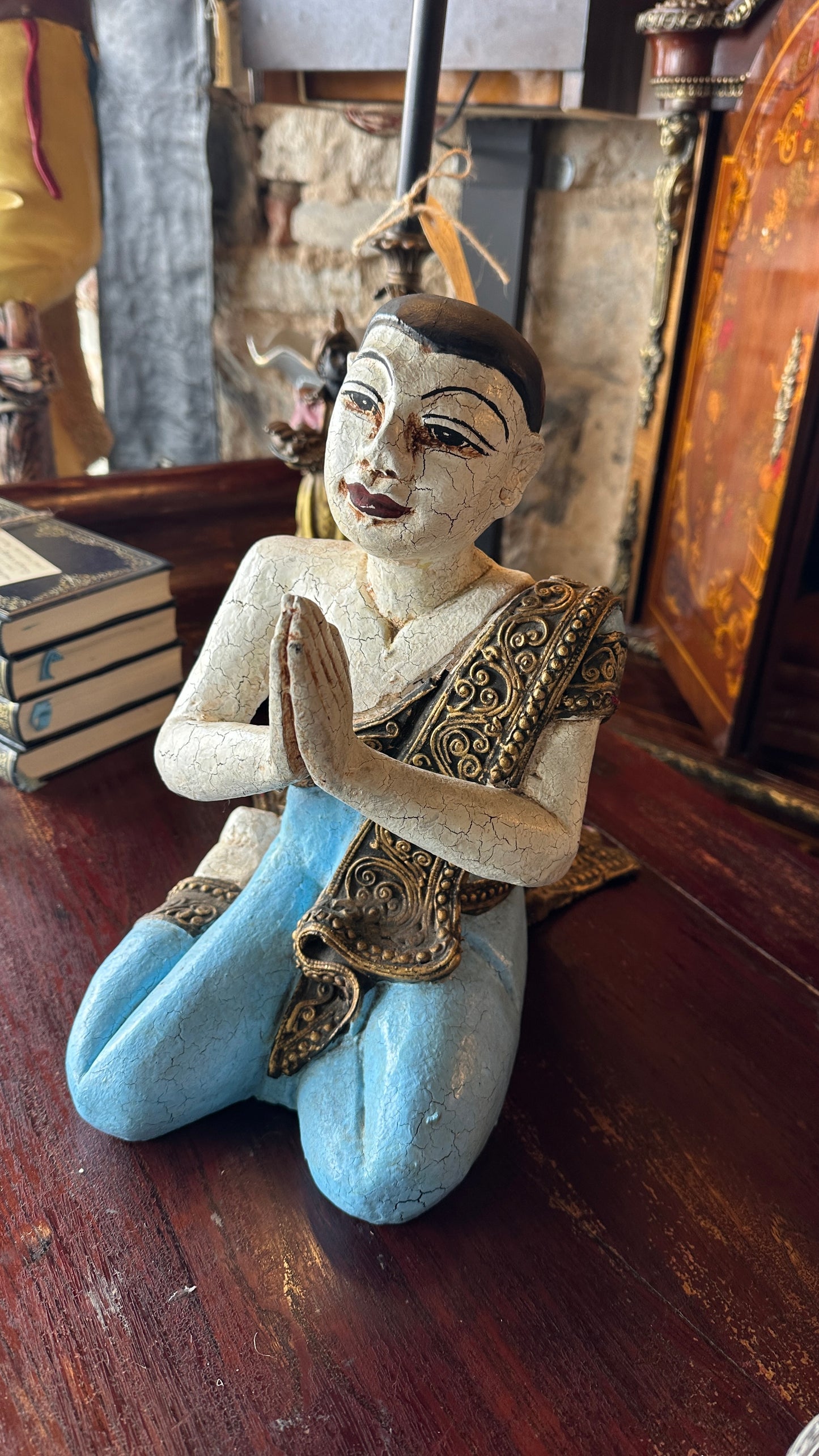 Vintage carved wooden sculpture of a praying monk