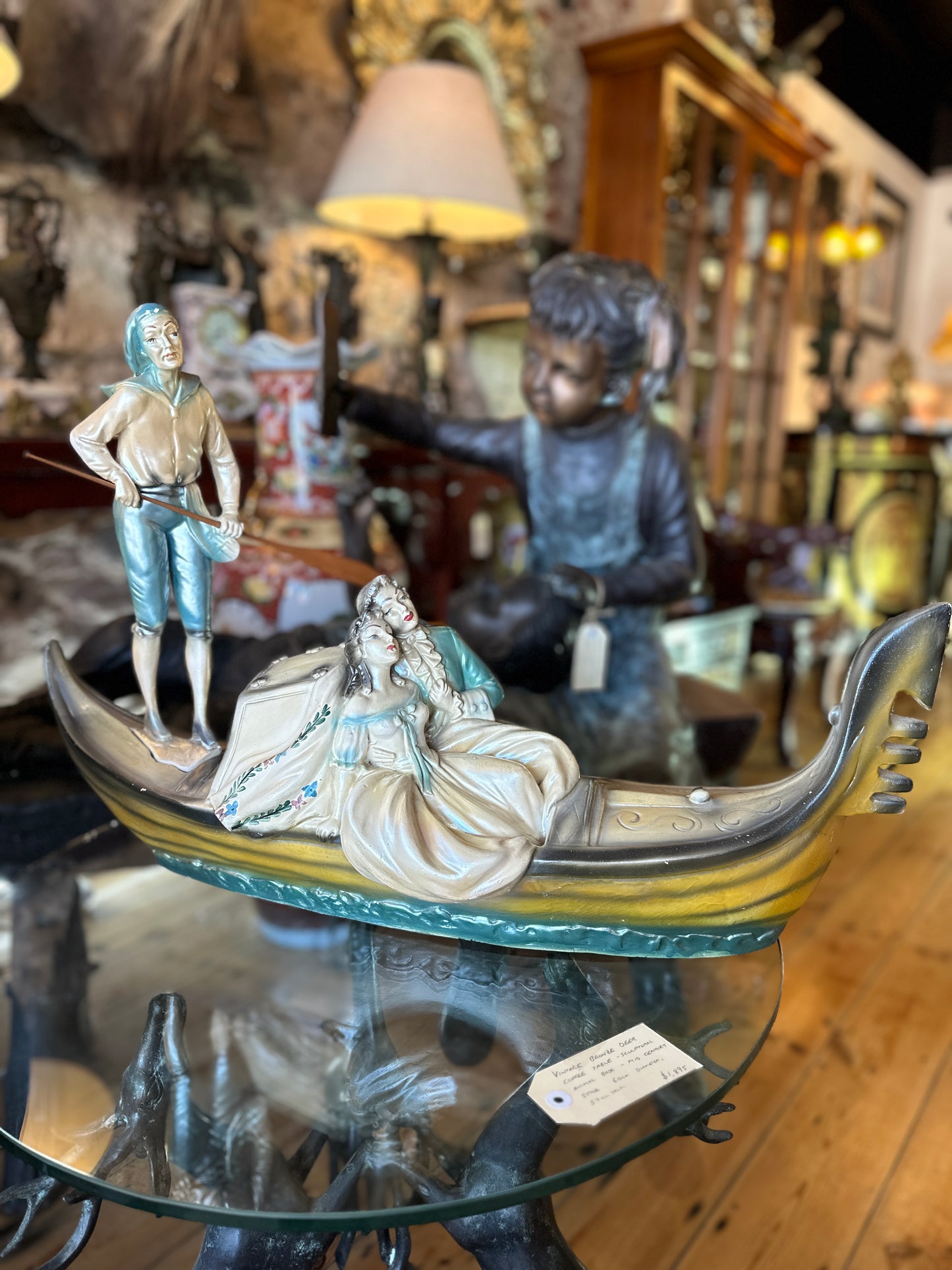 Vintage Venetian Gondola with Romantic Couple and Standing Gondolier with Wooden Oar