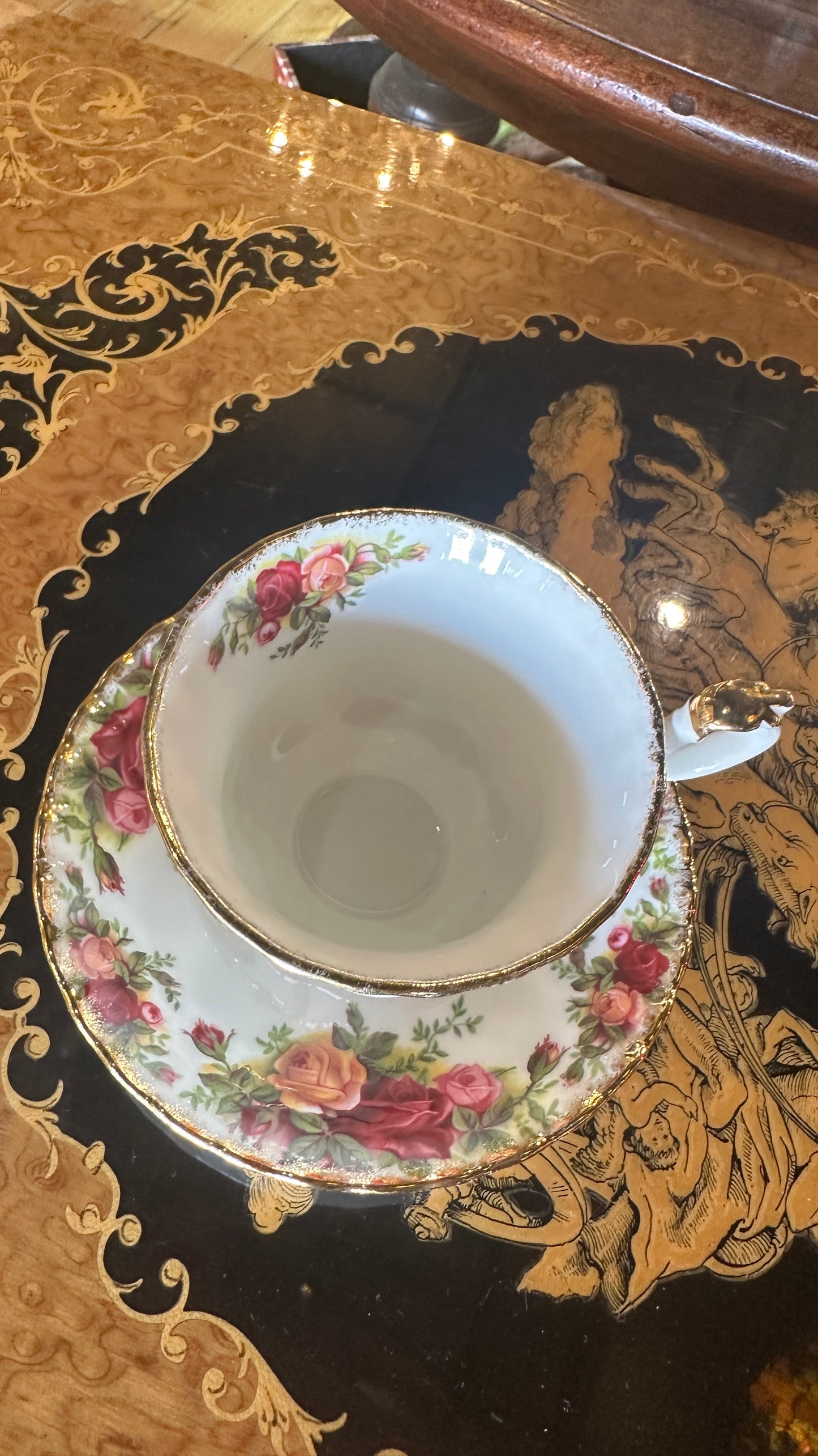 Teacup and saucer set in Prince Albert's “Old Country Roses” pattern trimmed in 22k gold