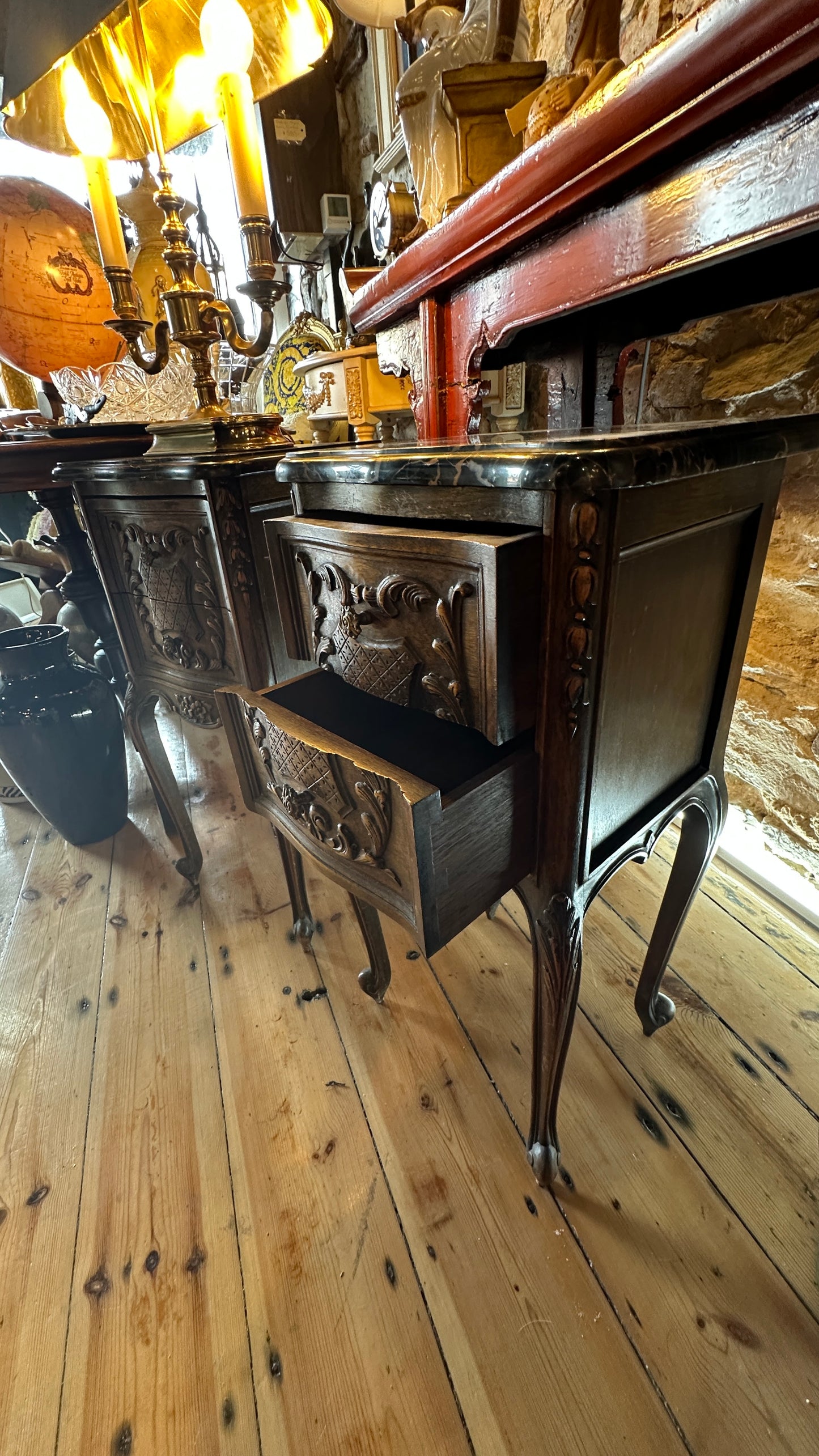Antique 19th-century French Louis XV style walnut side table with a black marble top and intricate Rococo carving, with two drawers