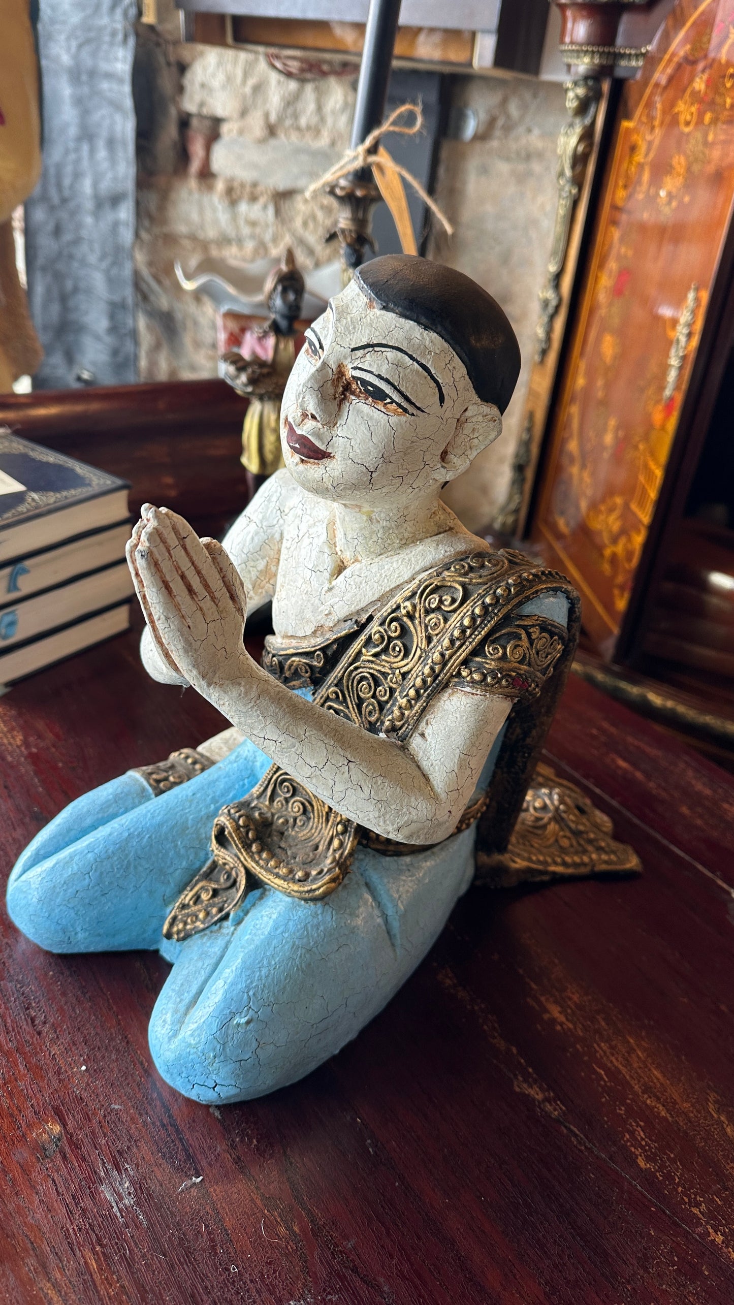 Vintage carved wooden sculpture of a praying monk