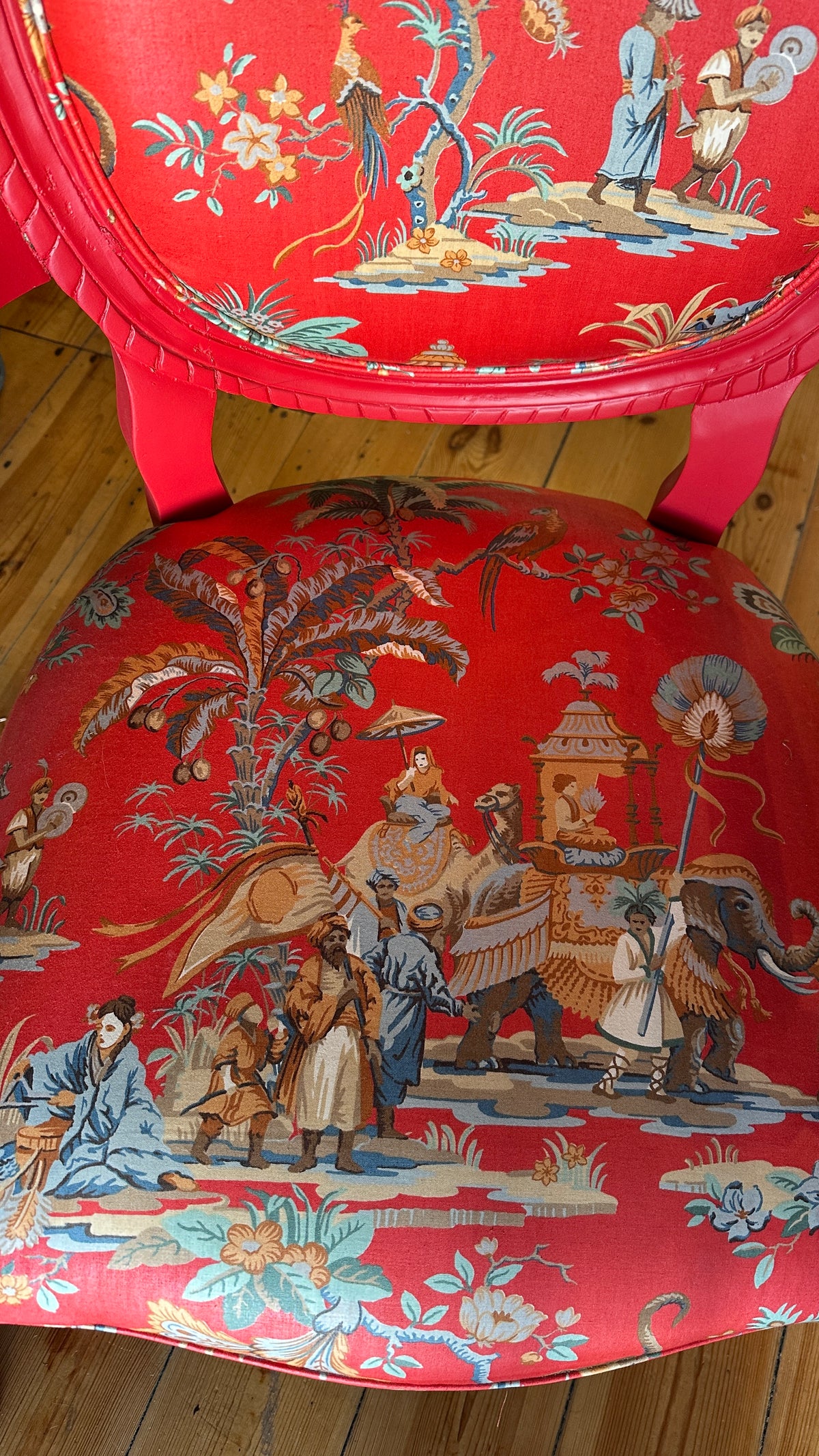 Striking Louis XVI-style armchair exquisitely upholstered in a red Chinoiserie garden scene motif