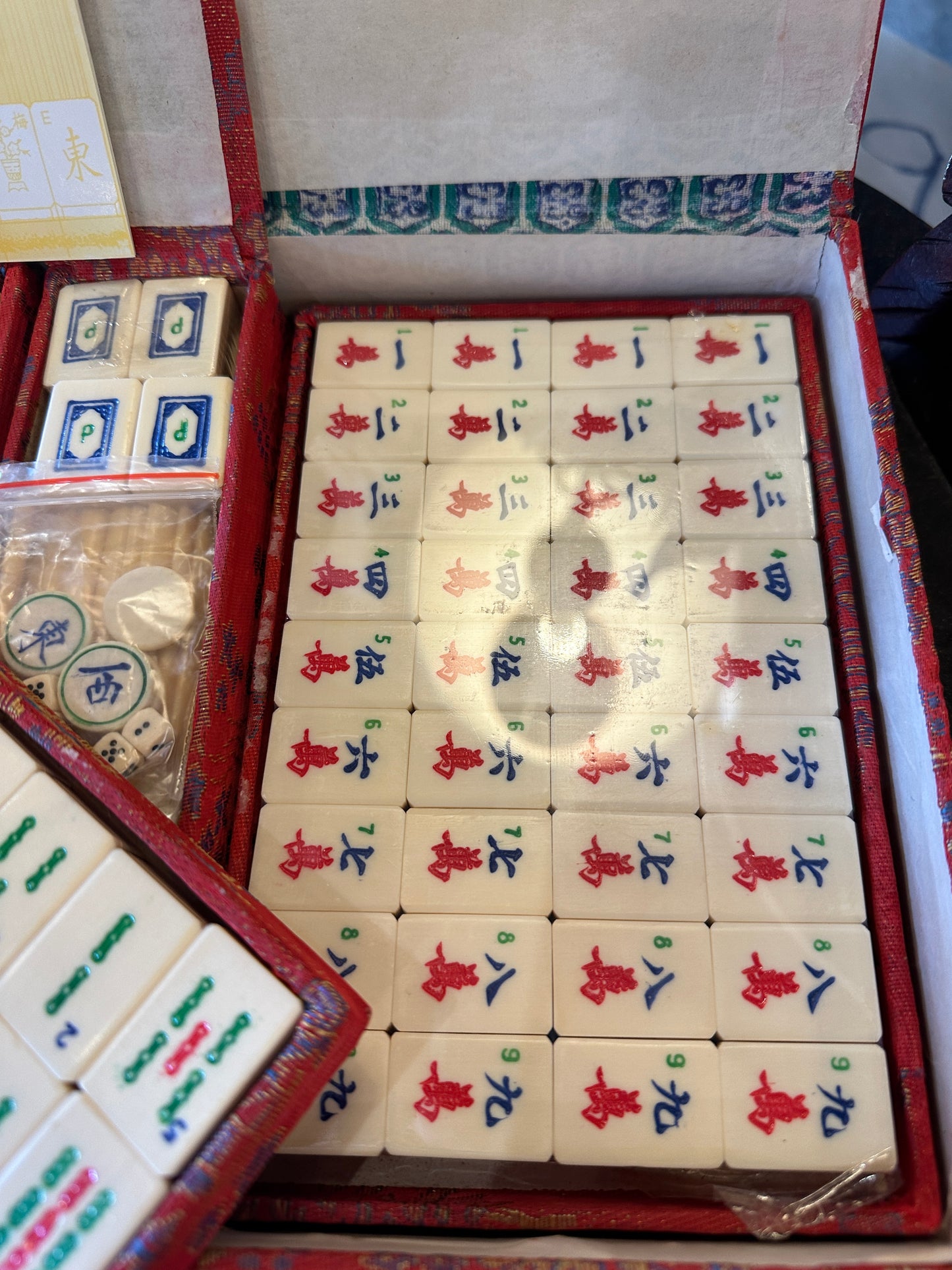 Vintage Mahjong set, including red brocade silk case and "Standard Rules" booklet