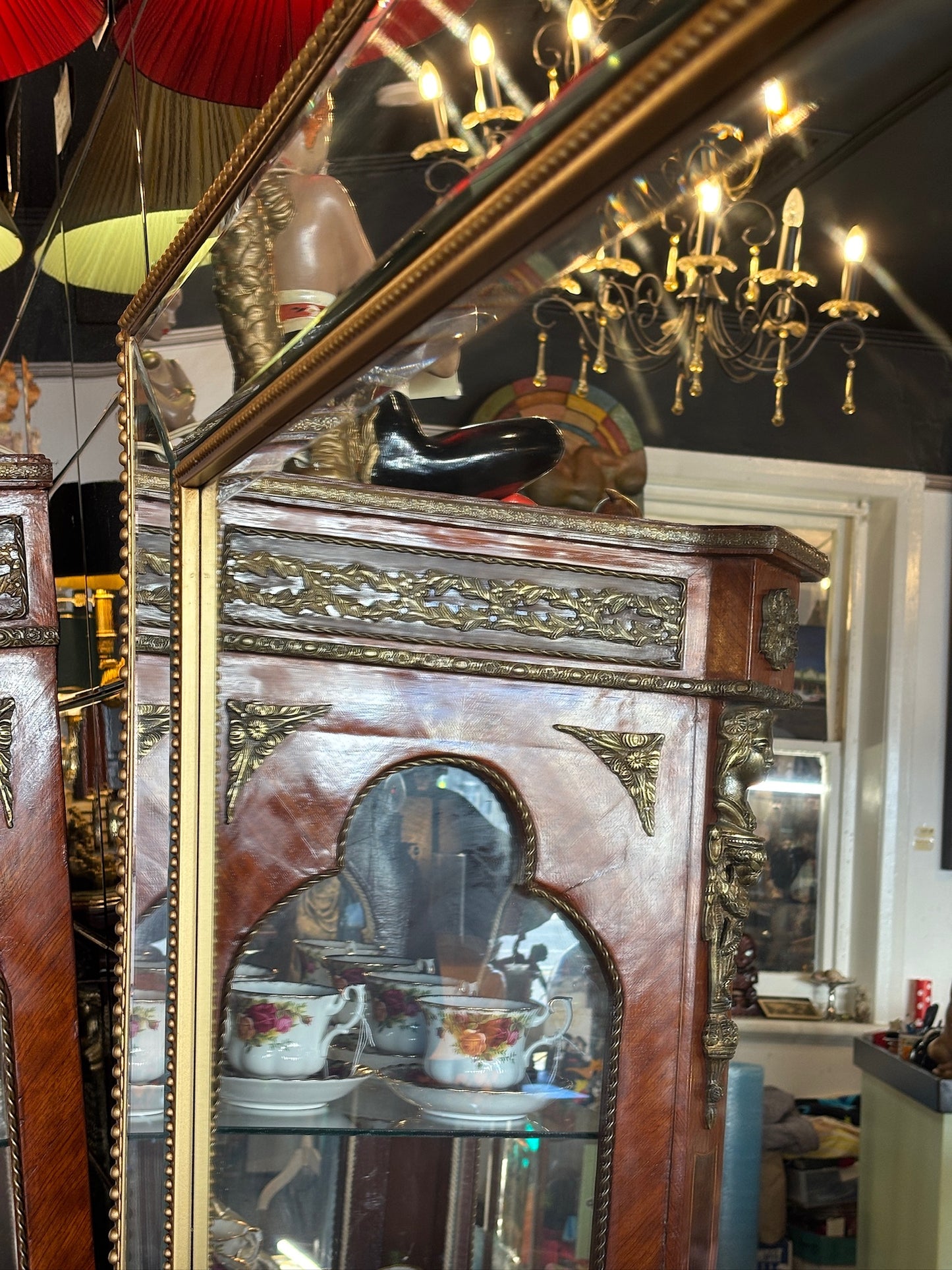 Large mirror features a classic bevel-edged glass pane set within a slender gold-beaded wooden frame