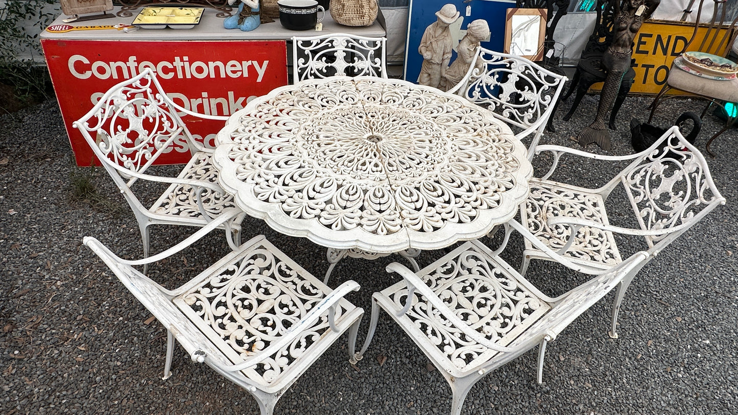 7-piece cast aluminum outdoor dining set with round table and 6 ornate chairs