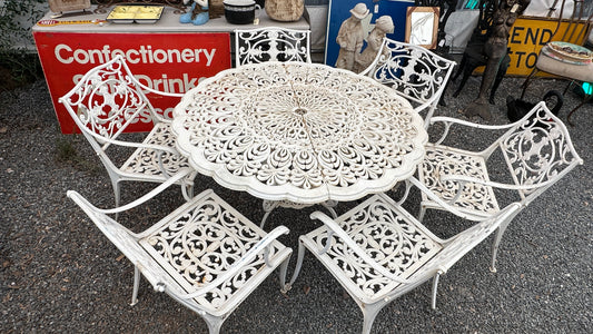 7-piece cast aluminum outdoor dining set with round table and 6 ornate chairs