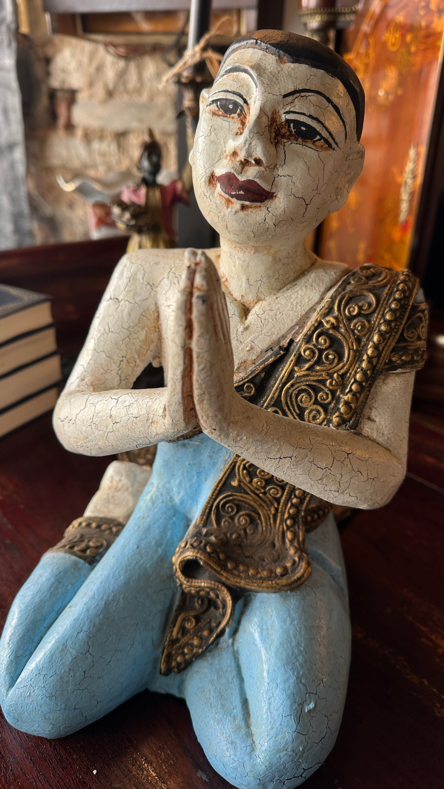 Vintage carved wooden sculpture of a praying monk