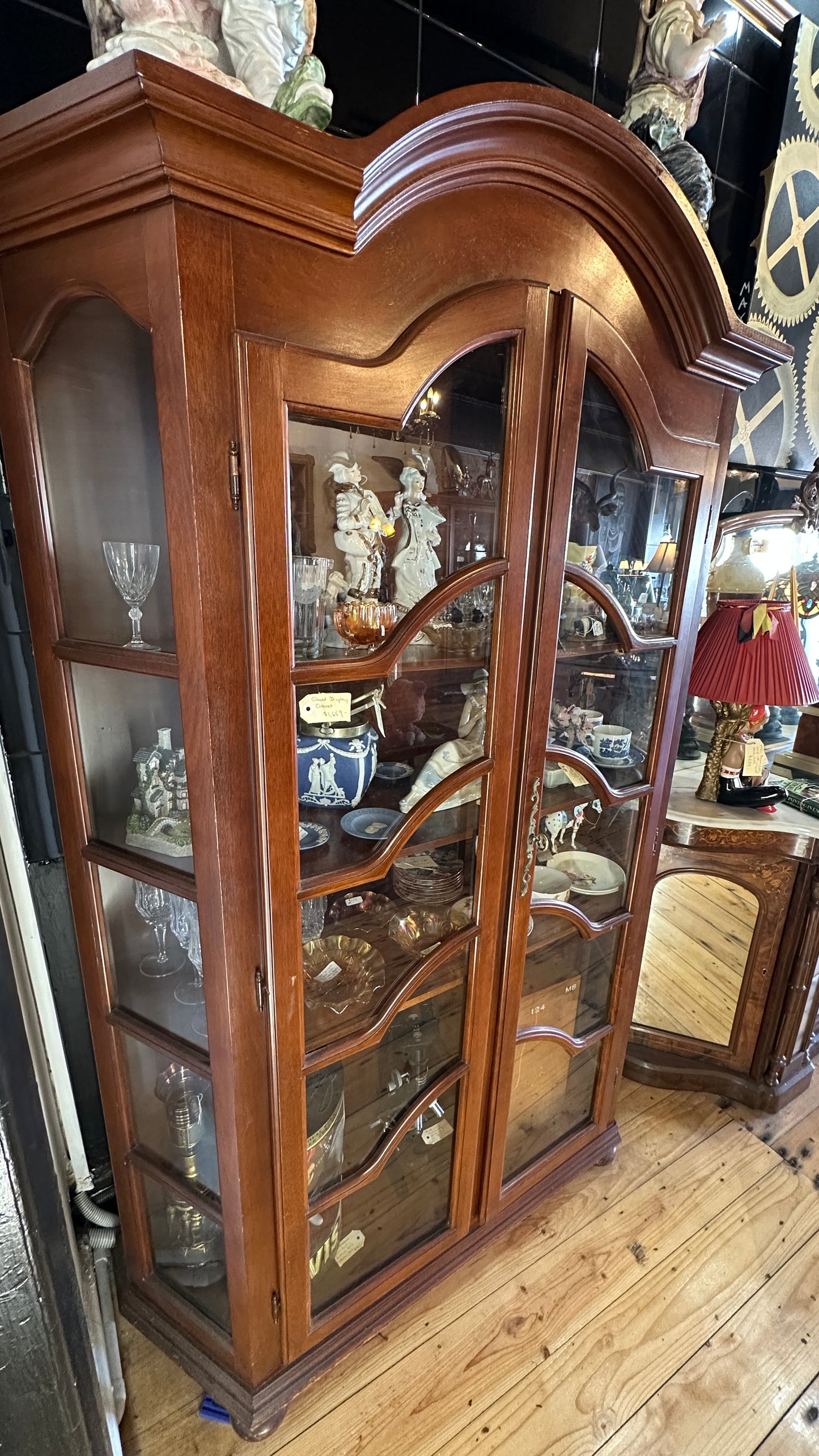 Display cabinet (or vitrine) featuring glass doors and side panels, with key