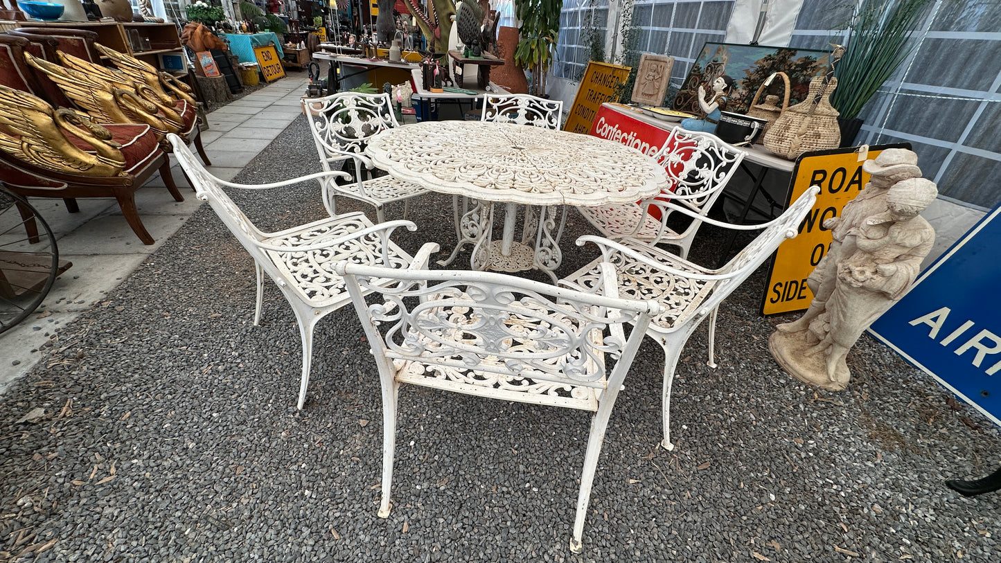 7-piece cast aluminum outdoor dining set with round table and 6 ornate chairs