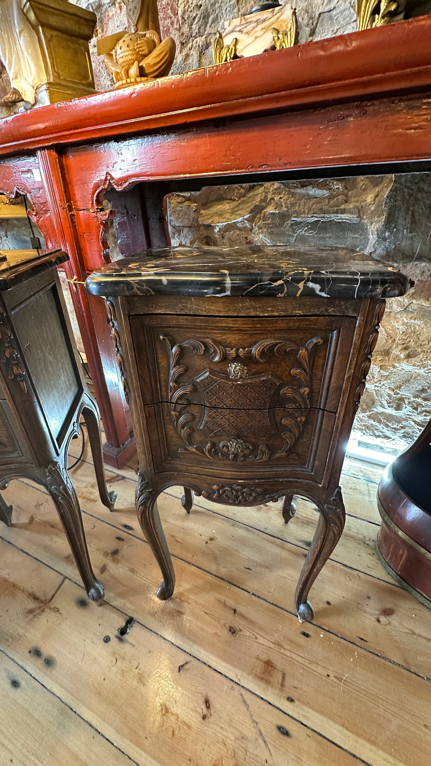 Antique 19th-century French Louis XV style walnut side table with a black marble top and intricate Rococo carving, with two drawers