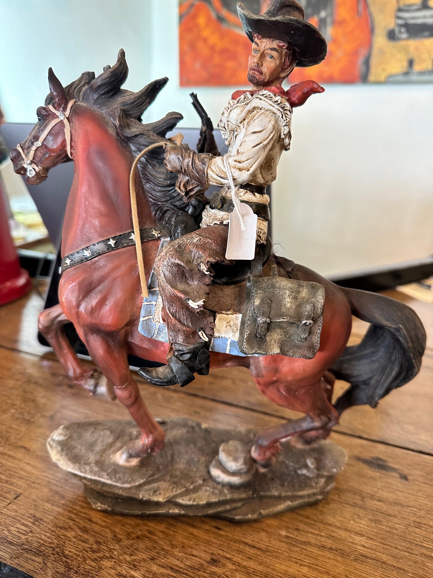 Cowboy riding horse figurine