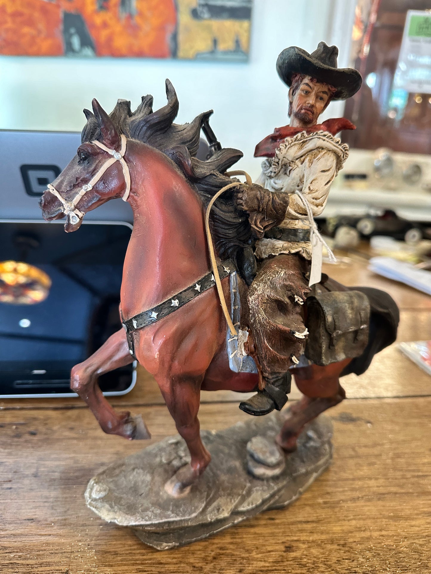 Cowboy riding horse figurine