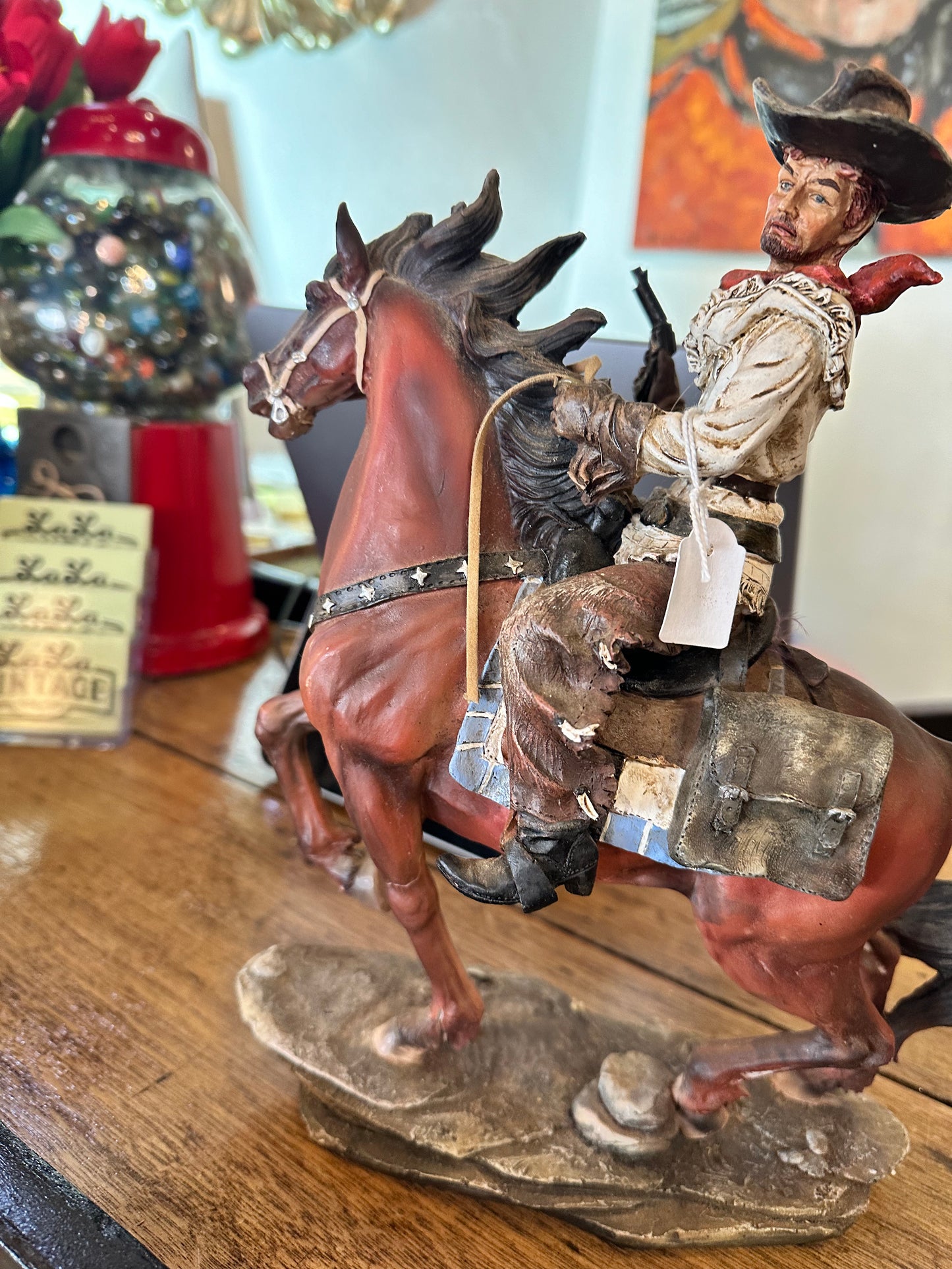 Cowboy riding horse figurine